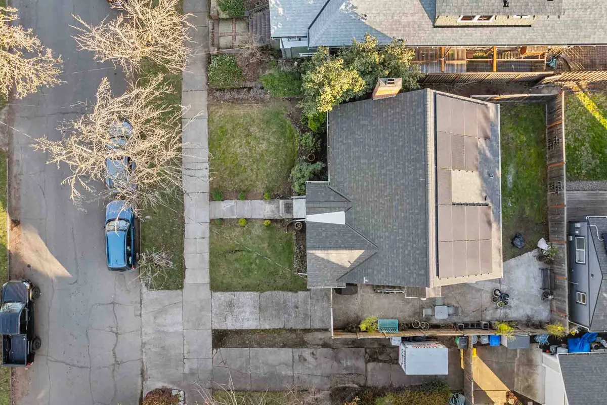 A view of the house with a pathway leading through surrounding trees, highlighting a sense of connection between home and the outdoors. The lush greenery and accessible path invite residents to step out and explore the nearby neighborhood.