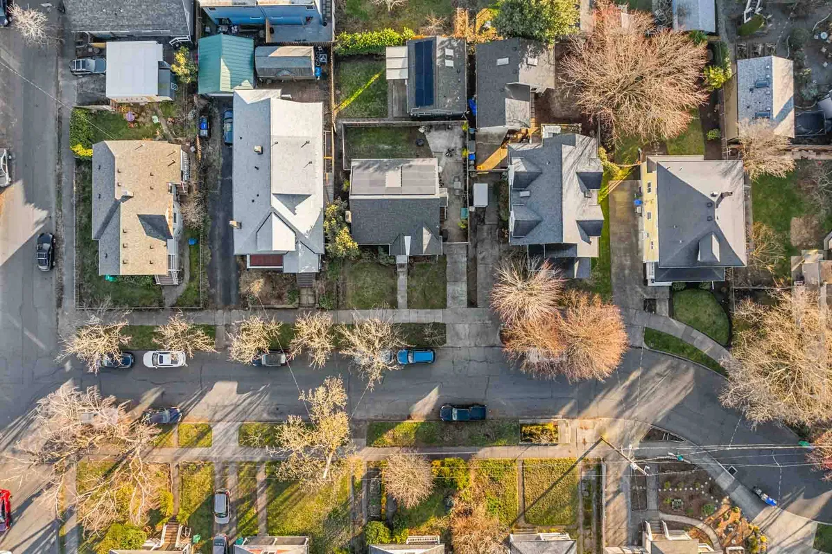 This image captures a quintessential Portland neighborhood scene: residential houses set along tree-lined streets, with manicured lawns and a warm, inviting atmosphere. The focus is on the friendly, walkable environment that supports outdoor strolls and community gatherings.